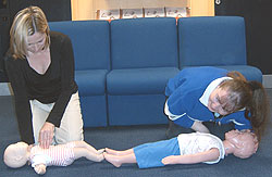 Sinead Dixon & Edel Gaffney practicising their child and infant life saving skills.